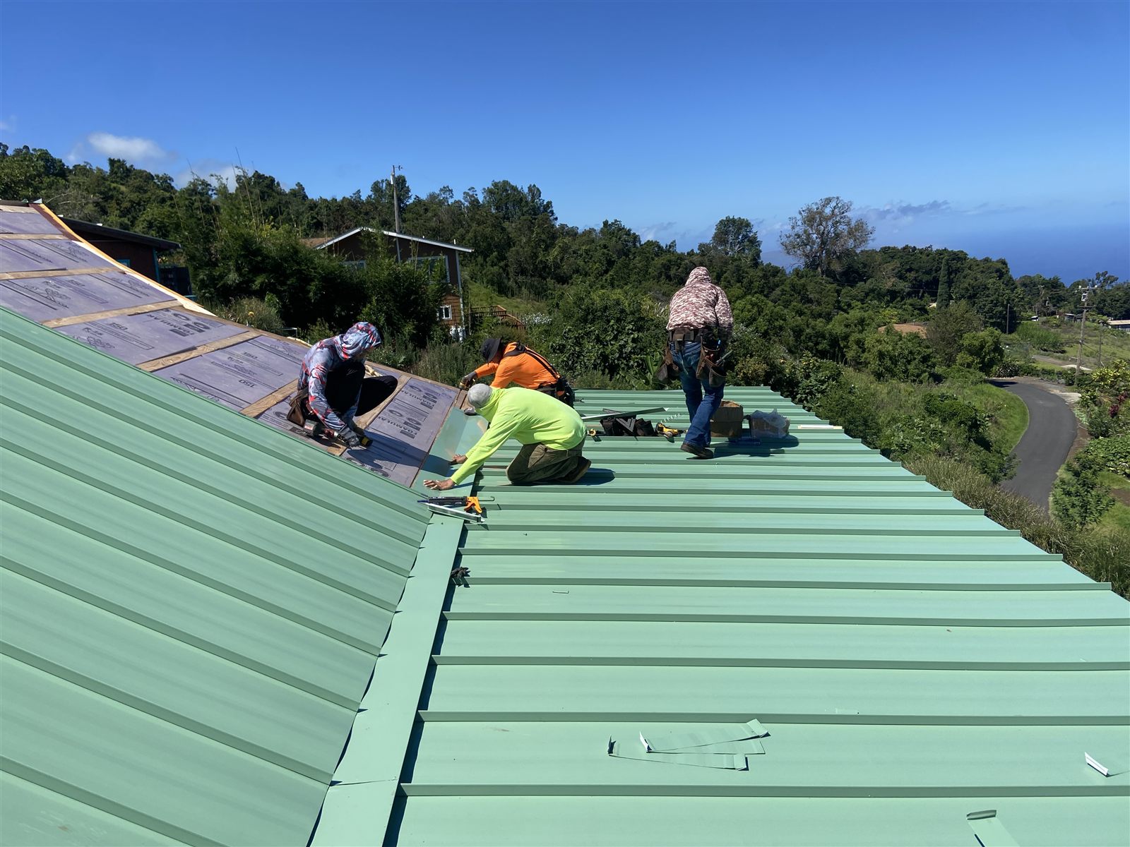 Our crew installing a green standing seam roof, upcountry Maui