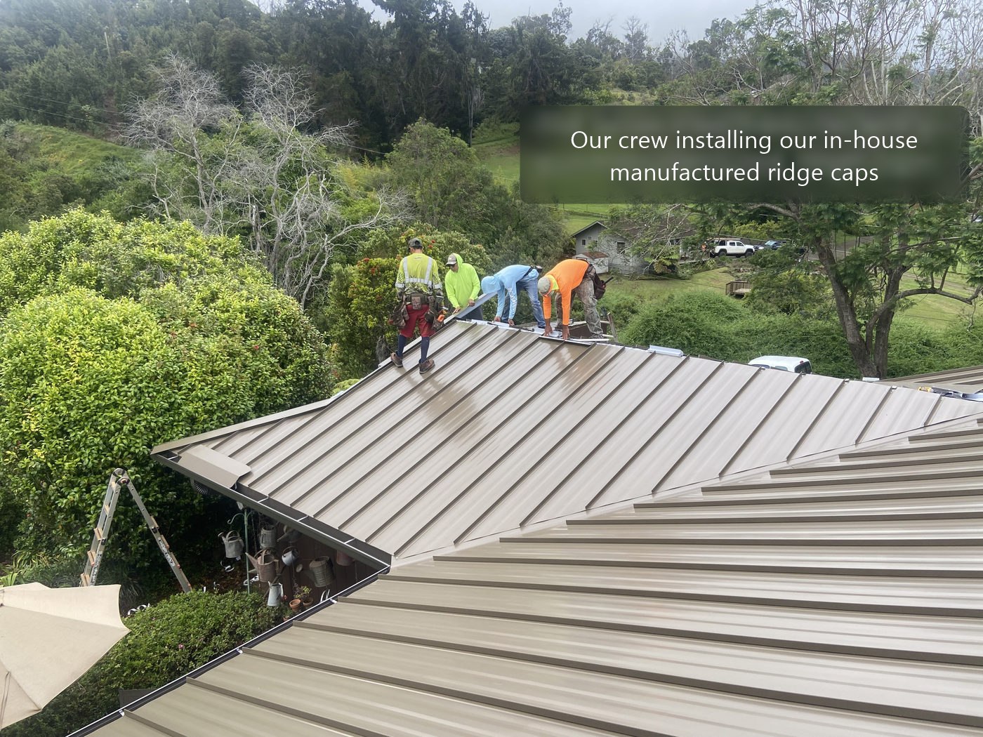 Our crew installing our in-house manufactured ridge caps