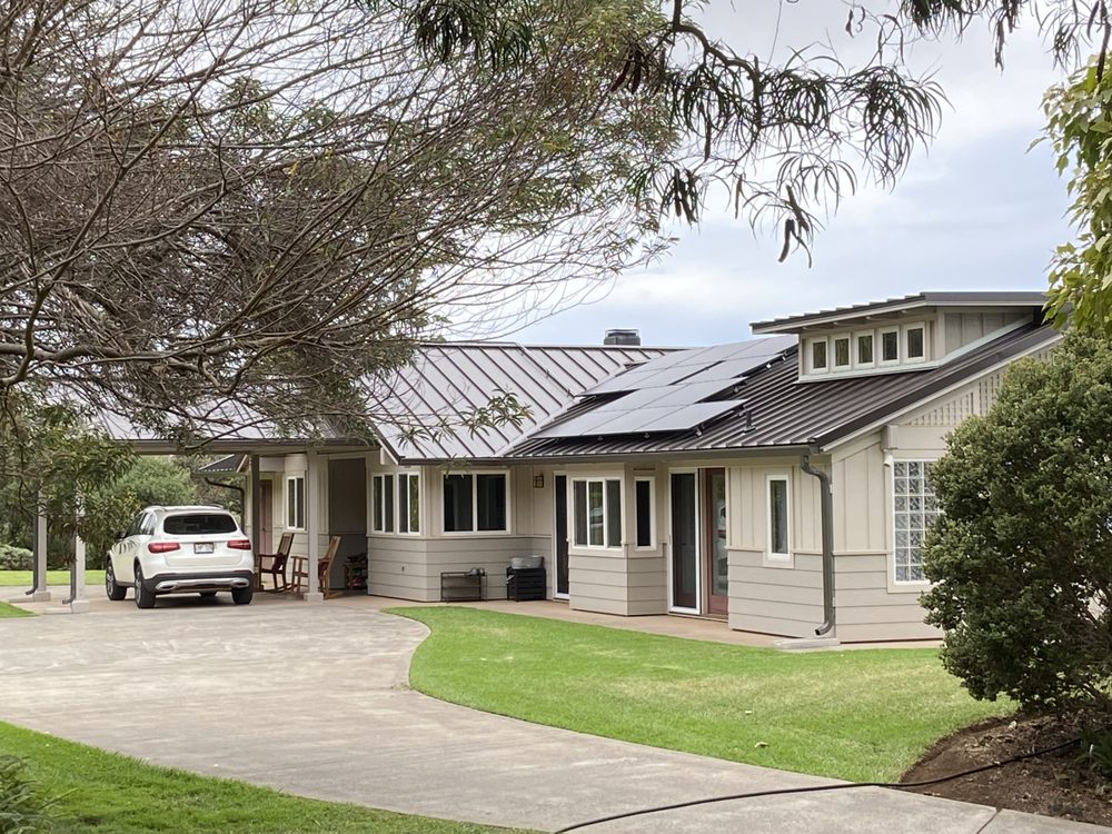 Completed standing seam metal roof with solar on an upcountry Maui home