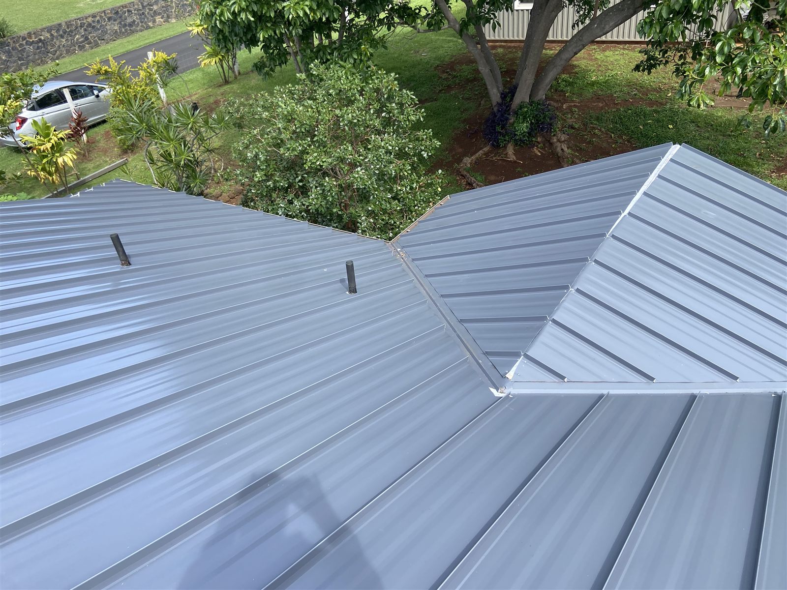 Precision valley and hip work on a slate-blue standing seam roof